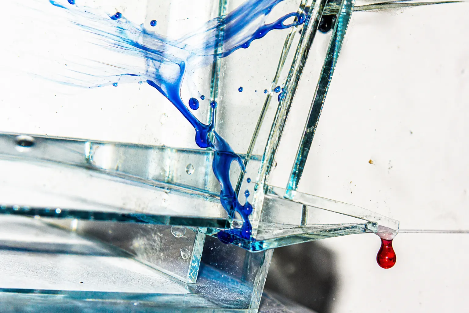 Cobalt liquid moving through clear glass gates